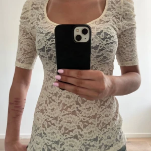 Vit spetsblus från Guess - Säljer en söt vit spetsblus från Guess med  spetsmaterial och små puffärmar. Blusen har rund halsringning och fina spetsdetaljer över hela plagget, skitsnygg till ALLT!! säljer då jag aldrig har på mig den men ABSOLUT inte något fel på den eller något fult!