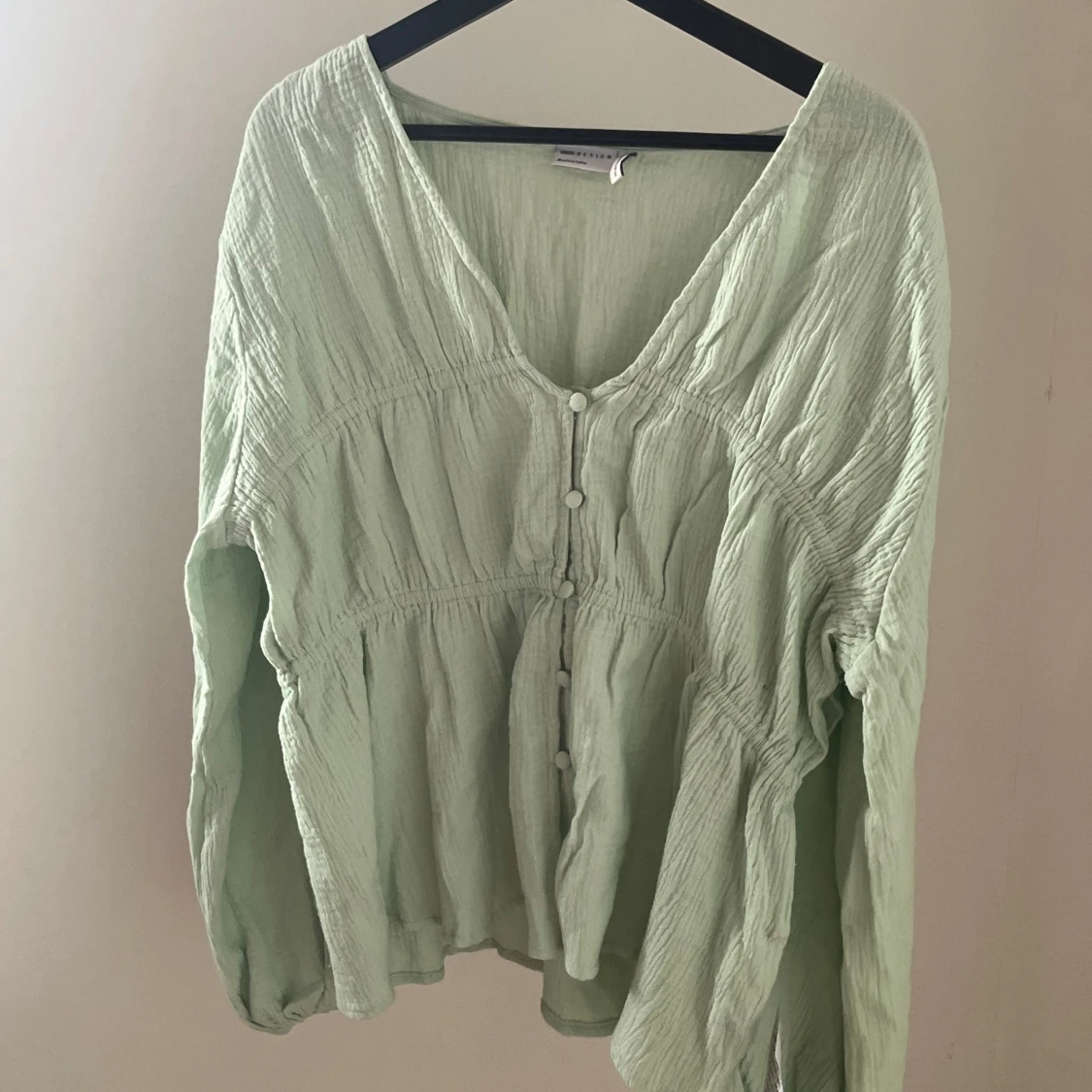 Ljusgrön tröja med knäppning framtill