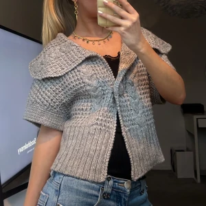 Grå stickad kofta med krage - Säljer en snygg grå stickad kofta med stor krage och korta ärmar. Perfekt för lager-på-lager och ger en trendig look. Passar bra till jeans eller kjol. Kontakta mig för mer info eller köp direkt! 💫