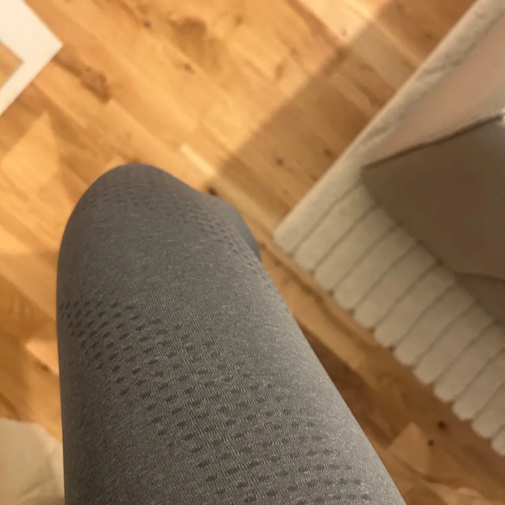 Snygga grå tights från Gymshark med hög midja och diskret mönster. Perfekta för träning med en tight passform som ger bra stöd. Materialet är stretchigt och bekvämt.. Sportswear.