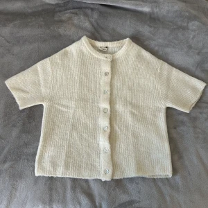 Vit stickad kofta från gina tricot - Säljer den här jätte söta stickade koftan från gina tricot med korta ärmar. Perfekt nu till våren💕