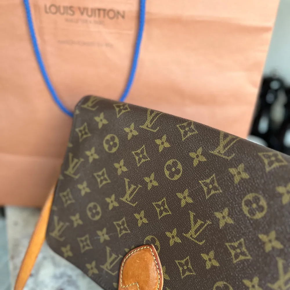 Säljer en elegant brun axelväska från Louis Vuitton med det klassiska monogrammönstret. Väskan har en justerbar axelrem i läder och en stilren design som passar perfekt för alla tillfällen. Ett måste för den stilmedvetna!. Laukut & Käsilaukut.