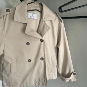 Trenchcoat  - Snygg beige trenchcoat från stradivarius. Har sammanhörande midje band/snöre. Varsamt använd så inga defekter, lite fläckar på bilderna men inget som inte går bort i tvätten. Säljer då den tyvärr inte kommer till mycket användning längre, skriv för fler bilder☺️