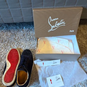 Christian Louboutin  - Snygga svarta sneakers från Christian Louboutin i storlek 43 då de tillkommer en box kort och dustbag  skorna är ganska bra skick lite slitna de är en spik som har låsnat men de är inget man tänker på  men går att fixa  har du några frågor eller funderingar tveka inte på att höra av er 