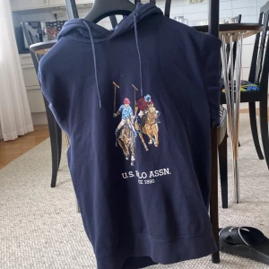 Marinblå hoodie från U.S. Polo Assn. - Säljer en marinblå hoodie från U.S. Polo Assn. Strl M men passar dig som bär S. (Jag bär M men denna tröja är för liten för mig) hör av er om fler bilder eller några funderingar!