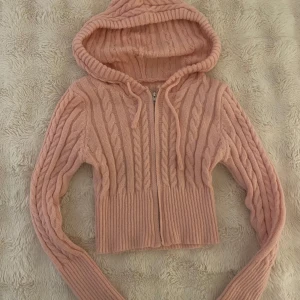 Rosa cropped stickad tröja - Super gullig och bekväm stickad rosa jacka/hoodie/tröja nästan helt oanvänd. Köpt second hand (helt oanvänd från förra säljaren) och i mycket bra skick! Uppskattat i storlek S men rätt så ”figurformad” så passar även Xs och M. Skriv kring fler frågor eller bilder!🩷🩷