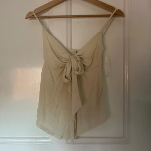 Topp ifrån gina tricot - Jättegullig topp ifrån gina med knytning där fram. Den är krämvit i färgen och har ett jätte skönt material. Aldrig använt, pris kan diskuteras