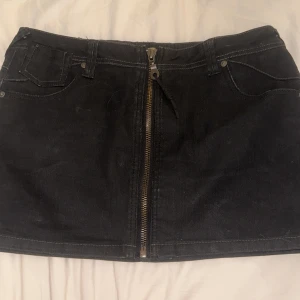 Svart jeanskjol från ONLY med dragkedja - Säljer en svart jeanskjol från ONLY. Kjolen är kort och har en snygg dragkedja framtill, klassiska fickor både fram och bak samt coola detaljer på bakfickorna!💕 Använd ett par gånger men inte mycket✨ Kan diskutera pris❤️