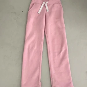 Rosa mjukisbyxor med snörning XXS - Säljer ett par ljusrosa mjukisbyxor från R i storlek XXS. Byxorna har vit snörning i midjan och raka ben. Mjukt och mysigt material, perfekta för chill dagar. Fickor på sidorna för extra bekvämlighet.