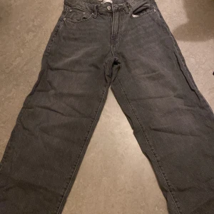 Svarta jeans från Perfect Jeans, stl 34 - Säljer ett par svarta jeans från Perfect Jeans i storlek 34. Jeansen har rak passform, klassisk femficksdesign och är tillverkade i ett robust jeanstyg. Perfekta för dig som gillar en enkel och clean look.