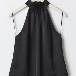 Svart halternecktopp - Super snygg svart halterneck topp från Gina tricot i satin material. Aldrig använd, helt ny med prislappen kvar och den går inte att köpa längre! Storlek 36💛💛