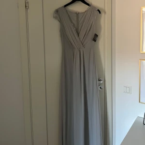 Ljusgrå balklänning med spetsdetaljer - En balklänning med spetsdetaljer som har kvar prislappen💕