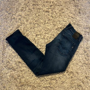 Mörkblå jeans från Replay modell anbass hyperflex  - Snygga blå jeans från Replay, modell Anbass med hyperflex. De har en klassisk femficksdesign och en bekväm passform. Perfekta för en avslappnad stil. Fint skick, förutom att de är sydda innuti ena fickan, inget som märks tydligt. Storlek 32/32 mått kan såklart skickas vid osäkerhet. Rriktigt mjuka och stretchiga i materialet. Postas antigen samma dag som köp eller dagen därpå, sänker priset 50kr vid snabb och smidig affär 💯🙌