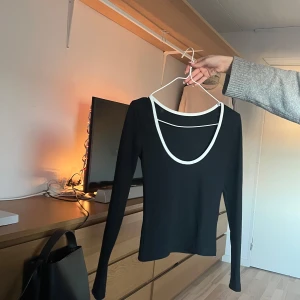 Svart urringad i ryggen topp med vitt kan - Man kan ha tröjan både bak och fram men är gjord för att den urringade ska vara i ryggen. Använd fåtal gånger i nyskick💕
