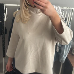 Beige polotröja - Säljer en stilren beige polotröja med trekvartsärm. Perfekt för en avslappnad och trendig look. Passar bra till både jeans och kjol.