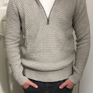 Grå stickad half zip-tröja Selected - Snygg grå stickad tröja från Selected Homme med halv dragkedja. Tröjan är använd 2 gånger max och är därför väldigt bra skick.