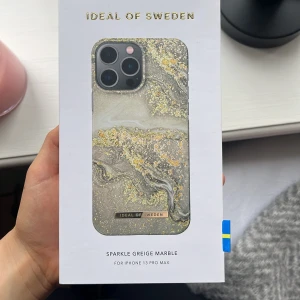 Sparkle Greige Marble mobilskal från iDeal of Sweden - Snyggt mobilskal till iPhone 13 Pro Max från iDeal of Sweden i marmorliknande design med grå, beige och guldiga toner. Skalets yta har glittriga detaljer och en lyxig känsla. Aldrig använt och helt nytt då jag råkade köpa fel🩷
