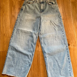 Wide jeans från ASOS Design ljusblå - Ljusblå jeans från ASOS Design med breda ben och råa kanter nertill. Hög midja och avslappnad passform. Aldrig använda. Midjemått är 76cm, 32-33cm i benvidd. 76 cm i längd