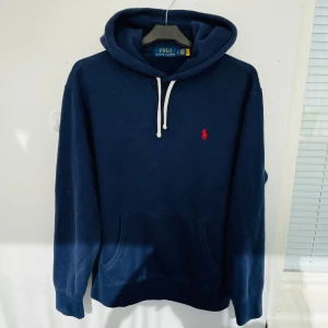 Ralph Lauren Marinblå Hoodie - Sjukt snygg och trendig Ralph Lauren Hoodie i en marinblå färg i storlek S. Nypris: 2300kr - Fraktar spårbart med PostNord/Instabox/Bring. Hör av dig vid funderingar!🤩