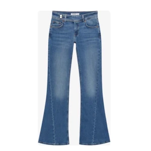 Blå bootcut jeans med låg midja - Jätte snygga blå bootcut jeans med en sne knäppning. Säljer då de tyvärr är för små för mig. De är slutsålda överallt och har slutat produceras💕