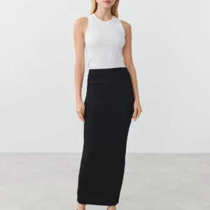 Svart långkjol - svart långkjol med en tight passform. Perfekt för en stilren look. Kjolen är enkel och tidlös, vilket gör den lätt att matcha med olika toppar. Använd fåtal gånger.