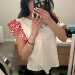 Vit blus med röda volangärmar Zara - Supersöt vit blus från Zara med volangärmar i rött och vitt blommönster 