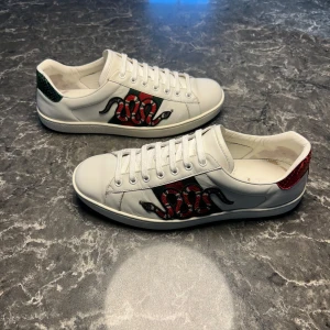 Gucci ace snake - Säljer ett par otroligt snygga skor från det exklusiva italienska märket Gucci! Skorna är i otroligt bra skick, skulle säga ungefär 9/10. Nypris ligger på över 9000kronor men vi säljer våra för endast 2399 och kan gå ner i pris ännu mer vid snabb affär! Skriv gärna ifall det är några funderingar, allt bästa SkoKapet