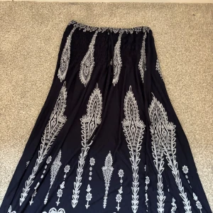 Svart långkjol med vitt mönster - Marinblå långkjol köpt på nån marknad i Spanien,säljer för ja inte har använt dem sen ja va i spanien pris kan diskuteras🩷