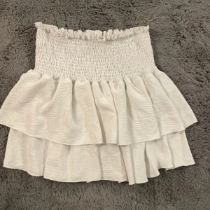 Volangkjol - Kort vit volangkjol! Storlek står inte men passar S-L då den är stretchig!💗Aldrig använd