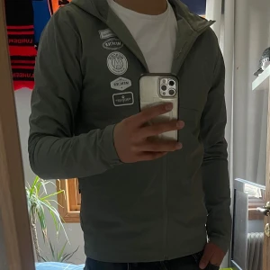 Grå vindjacka - | Säljer en perfekt och unik vindjacka från märket Mercier och går inte att få tag på längre | Väldigt bra skick 9/10 då den är varsamt använd | Enda defekten är att ett av märkena är lite slitet (bild 4) men man tänker inte på det |   Storlek M | Perfekt plagg nu när det börjar bli lite varmare ute | Orginal pris 1500 med frakten mitt pris 699 |