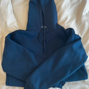 Mörkblå hoodie från BikBok XS - Mysig mörkblå hoodie från BikBok i storlek XS. Tröjan har huva med snörning, magficka och ribbade muddar vid ärmslut och nederkant. 