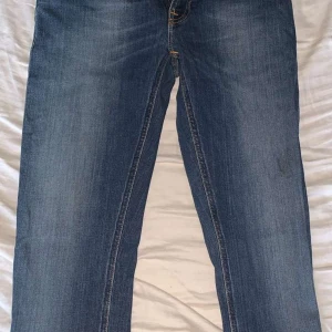 Blå jeans med raka ben - Klassiska blå jeans med raka ben och snygga detaljer på bakfickorna. Jeansen har normal passform och är tillverkade i slitstarkt denimtyg. Perfekta för en avslappnad och stilren look.