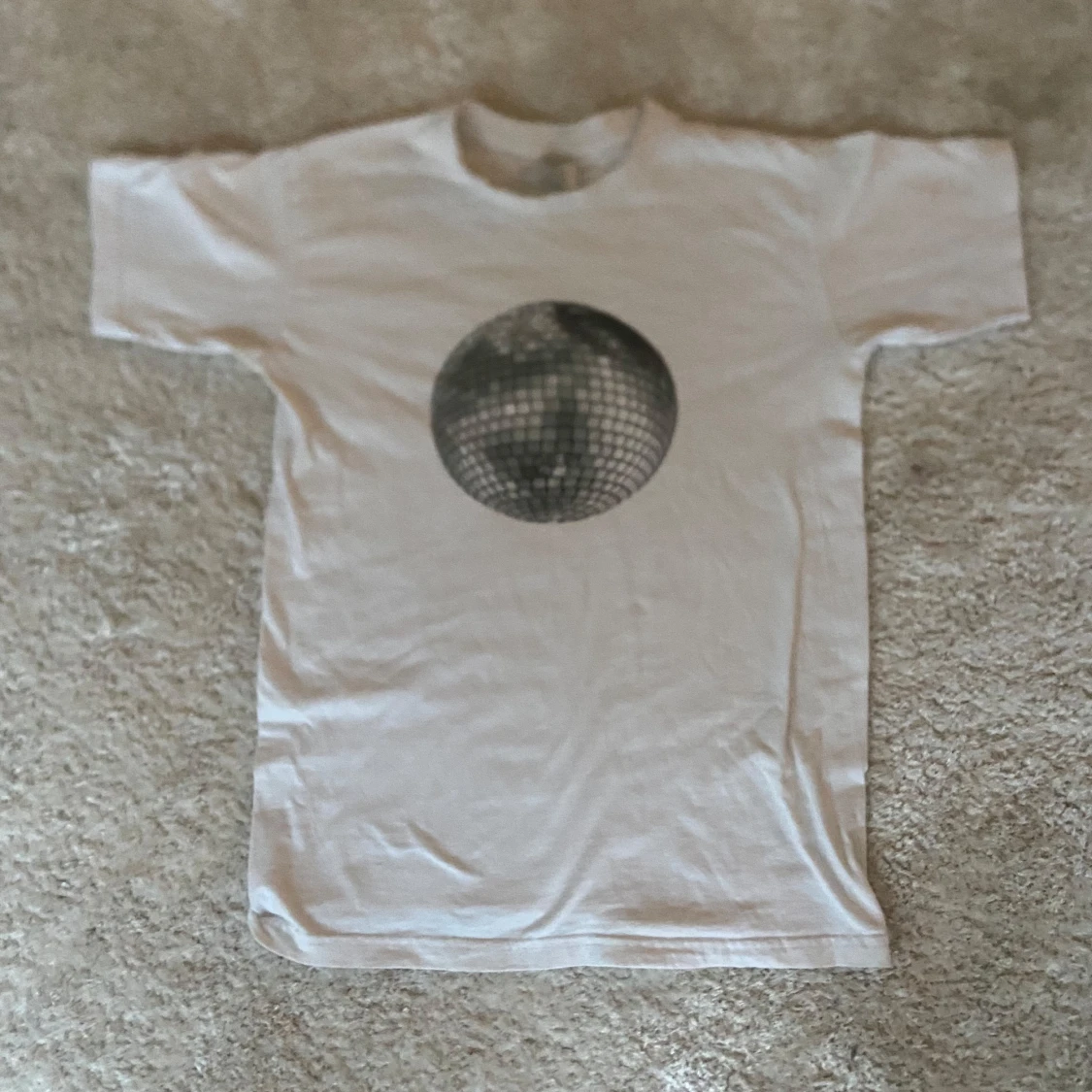 Vit t-shirt med discokula från B&C Collection.