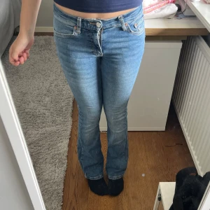 Blå bootcut jeans från Gina Tricot - Snygga blå bootcut jeans från Gina Tricot med klassisk femficksdesign och dragkedja. Jeansen är tillverkade i mjukt denimtyg med lite stretch. Jag har vanligtvis storlek 34, och dem sitter lite tight på mig. 