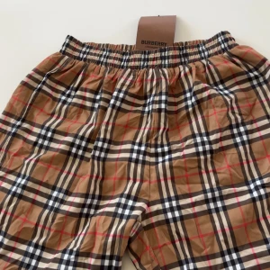 Rutigta Burberry shorts i beige - Snygga shorts från Burberry i klassiskt rutigt mönster med beige, svart, vitt och röda detaljer. Elastisk midja och meshfoder på insidan för extra komfort. Perfekta för sommardagar när du vill sticka ut med en ikonisk look. Pris går självklart att diskutera