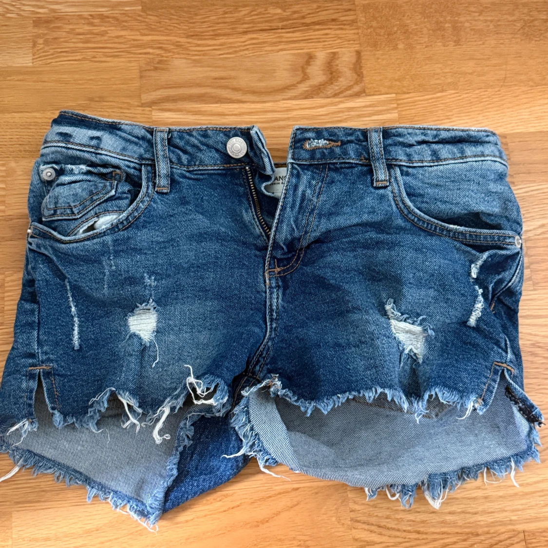 Blå jeansshorts med slitningar från MNG