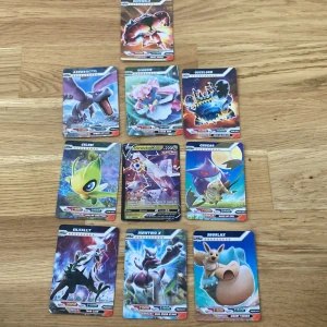 Pokémonkort samling 7kr styck - Samling av 10 Pokémonkort med olika motiv, inklusive populära Pokémon som Aerodactyl, Diancie, Guzzlord, Celebi, Gengar, Silvally, Mewtwo X , Snorlax, Celebi, Duraludon och Buzzwole. Korten har färgglada illustrationer och är tryckta på matt papper. Perfekt för samlare eller Pokémon-fans.