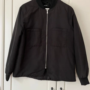 Svart bomberjacka från Vero Moda - Snygg svart bomberjacka från Vero Moda med dragkedja framtill och två stora fickor. 