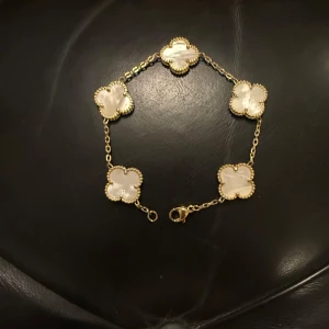 En van cleef and arpels liknande armband  - Säljer min van cleef and aprels liknande armband som är guldplaterade och har liknande vita färgen av en pärla som köptes för 1000kr men kan säljas för 700 samt kan prsiet sänkas också eftersom den är använd ett fåtal gånger fast än den är i ny skick!