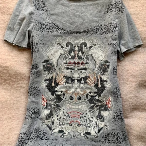 Grå t-shirt - Unik grå t-shirt med små diamant liknande detaljer💫 Säljer då den aldrig kommit till användning och är därför i fint skick! Passar allt från xs-m beroende på hur man vill att den ska sitta💘