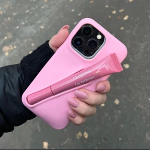 Rosa mobilskal från AMORE UF - Mobilskal från AMORE UF i färgen AMORE BLUSH i storleken 13/14/15 PRO. Stilrent mobilskal med en hållare som rymmer flera olika läppglans💗💕