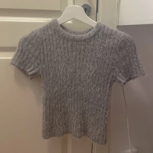 Grå stickad topp - Säljer denna grå stickade topp i storlek xs. Väldigt bra skick knappt använd 🩶