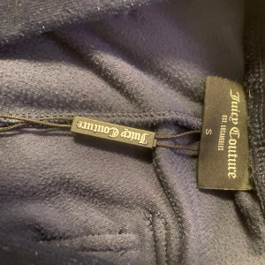 Mörkblåa mjukisbyxor från Juicy Couture - Säljer ett par svarta mjukisbyxor från Juicy Couture i storlek S. Supermjuka och fina!  (Säljer pg av fel storlek) Använda en gång helt ny skick 