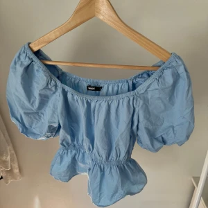 Blå topp från Bik Bok - Säljer en superfin blå  topp från Bik Bok. Den har puffiga korta ärmar och är i nyskick.🩵
