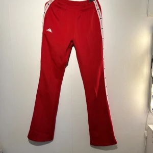 Röda kappa bootcut byxor  - Kommer tyvärr inte till användning mer men är i bra skick förutom längs ner på byxorna då byxorna är för långa för mig. För referens är jag 170 lång.   Säljs för 500kr. Pris kan diskuteras. Köparen står för frakten. 