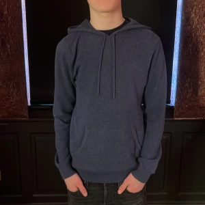 Marinblå kashmir luvtröja från John Henric - Säljer en stilren blå hoodie från John Henric i kashmir. Tröjan har en klassisk design med huva och långa ärmar. Perfekt för en avslappnad look. Stilren för alla säsonger och kommer hålla dig varm inom dom kalla dagarna där man vill ha någonting snyggt. Använt endast en gång. Modellen är 170cm och 55kg men kommer passa perfekt om du är runt 175-180cm.