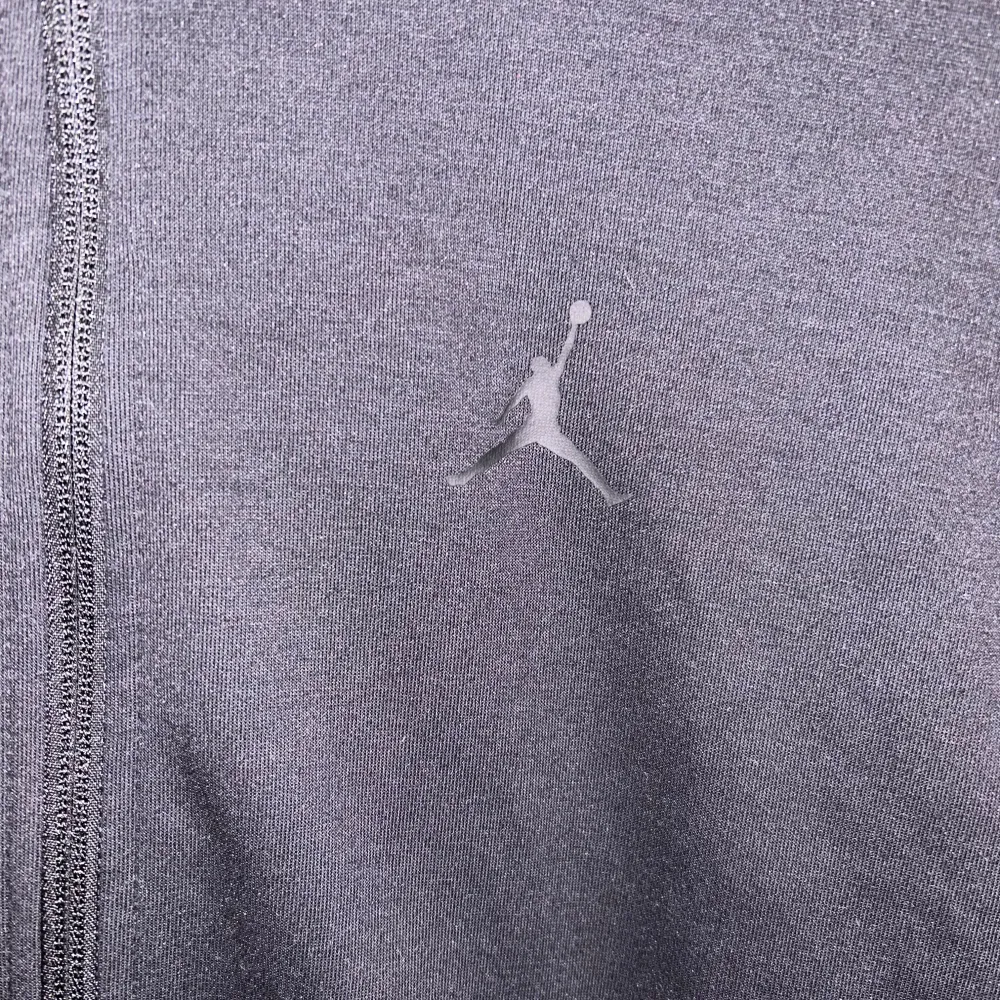 Säljer en svart hoodie från Jordan i bra skick. Den har en dragkedja framtill och en justerbar huva. Perfekt för både träning och vardagsbruk. Den ikoniska Jumpman-loggan syns på bröstet. Skön och stilren design som passar till det mesta.. Hoodies.