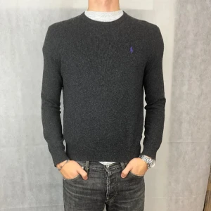 Grå tröja från Polo Ralph Lauren - Säljer en stilren mörkgrå tröja från Polo Ralph Lauren, materialet är 100% merinoull, storlek är S fast sitter liten i storleken. Priset kan diskuteras.