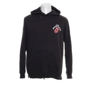 Svart Rolling Stones hoodie från H&M - Säljer en svart hoodie från H&M med det ikoniska Rolling Stones-logotypen på bröstet och ryggen. Tröjan har en klassisk känguruficka och justerbar huva med dragsko. Perfekt för fans av bandet! 🎸