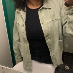 Grön jeans jacka  - Säljer en stilren grön overshirt med knappar framtill och två bröstfickor. Perfekt för lager-på-lager och en avslappnad look. Passar bra till både jeans och kjol.
